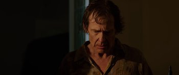 Movie still from “Band of Robbers” (2015), directed by Adam Nee – A person wearing a brown shirt; Close Up shot, Low angle