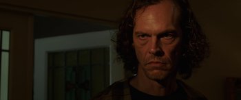 Movie still from “Band of Robbers” (2015), directed by Adam Nee – A person with long curly hair; Close Up shot, Low angle