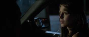 Movie still from “Band of Robbers” (2015), directed by Adam Nee – A woman sitting in the driver's seat of a car at night; Close Up shot, Over the shoulder angle