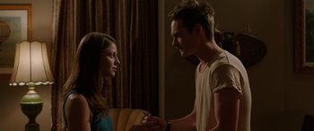 Movie still from “Band of Robbers” (2015), directed by Adam Nee – A man and a woman holding hands in a living room; Close Up shot, Over the shoulder angle