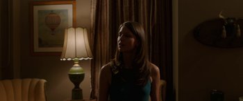 Movie still from “Band of Robbers” (2015), directed by Adam Nee – A beautiful young lady standing next to a lamp; Medium shot, Over the shoulder angle