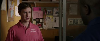 Movie still from “Band of Robbers” (2015), directed by Adam Nee – A woman standing in front of a glass door in a room; Close Up shot, Over the shoulder angle