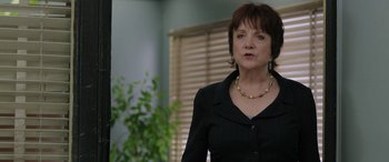 Movie still from “Band of Robbers” (2015), directed by Adam Nee – A woman wearing a black jacket and a necklace; Close Up shot, Over the shoulder angle