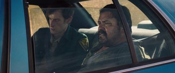 Movie still from “Band of Robbers” (2015), directed by Adam Nee – Two men in the back seat of a car; Medium shot, Over the shoulder angle