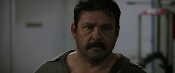 Movie still from “Band of Robbers” (2015), directed by Adam Nee – A person with a mustache; Close Up shot, Over the shoulder angle