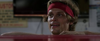 Movie still from “Band of Robbers” (2015), directed by Adam Nee – A person wearing a red headband; Close Up shot, Low angle
