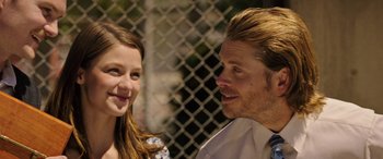 Movie still from “Band of Robbers” (2015), directed by Adam Nee – A man and a girl are smiling at each other; Close Up shot, Over the shoulder angle