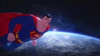 Movie still from “Batman and Superman: Battle of the Super Sons” (2022), directed by Matt Peters – A man in a superman costume flying over the earth; Wide shot, Low angle
