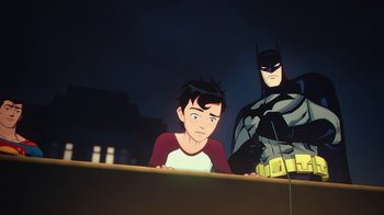 Movie still from “Batman and Superman: Battle of the Super Sons” (2022), directed by Matt Peters – A cartoon of a boy and a batman standing next to each other; Medium shot, Over the shoulder angle