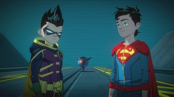 Movie still from “Batman and Superman: Battle of the Super Sons” (2022), directed by Matt Peters – Two young men standing next to each other; Medium shot, Over the shoulder angle
