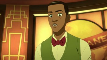 Movie still from “Batman and Superman: Battle of the Super Sons” (2022), directed by Matt Peters – A man in a green vest and a red bow tie; Close Up shot, Over the shoulder angle