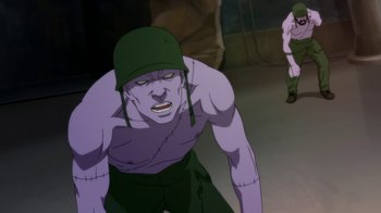 Movie still from “Batman: Death in the Family” (2020), directed by Brandon Vietti – An image of an evil looking man in a green hat; Medium shot, Low angle
