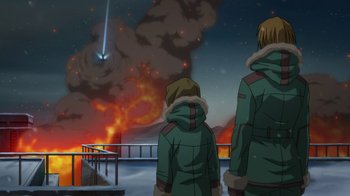 Movie still from “Batman: Death in the Family” (2020), directed by Brandon Vietti – Two people standing in front of an exploding fire; Extreme Wide shot, Over the shoulder angle