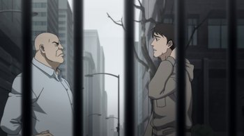 Movie still from “Batman: Death in the Family” (2020), directed by Brandon Vietti – Two men are standing next to each other in front of a fence; Medium shot, Over the shoulder angle
