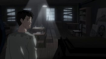 Movie still from “Batman: Death in the Family” (2020), directed by Brandon Vietti – A man standing in a dimly - lit room with a light shining on him; Medium shot, Over the shoulder angle