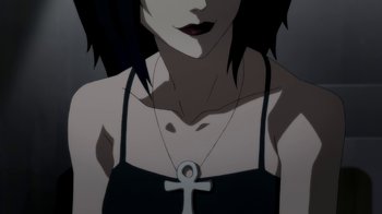 Movie still from “Batman: Death in the Family” (2020), directed by Brandon Vietti – A person wearing a necklace with a cross; Close Up shot, Low angle