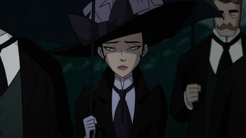 Movie still from “Batman: Gotham by Gaslight” (2018), directed by Sam Liu – A woman in a black suit holding an umbrella in the dark; Close Up shot, Over the shoulder angle