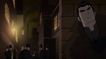 Movie still from “Batman: Gotham by Gaslight” (2018), directed by Sam Liu – A group of men standing next to each other in front of a brick building; Medium shot, Over the shoulder angle