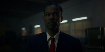 Movie still from “Fargo” (2014), created by Noah Hawley – A man wearing a suit and red neck tie; Close Up shot, Low angle