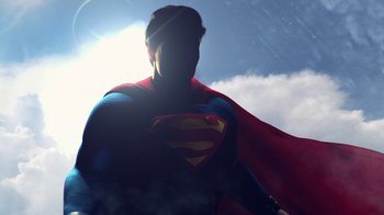 Movie still from “Batman: Hush” (2019), directed by Justin Copeland – A man in a superman costume standing in front of the sun; Medium shot, Low angle