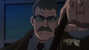 Movie still from “Batman: Hush” (2019), directed by Justin Copeland – An older man with a mustache wearing glasses and a jacket; Close Up shot, Low angle