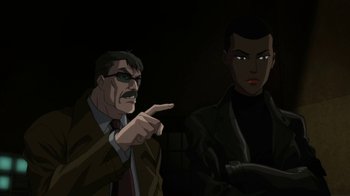 Movie still from “Batman: Hush” (2019), directed by Justin Copeland – A man and a woman are standing next to each other in the dark; Medium shot, Over the shoulder angle