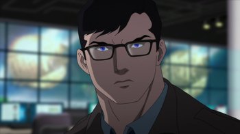 Movie still from “Batman: Hush” (2019), directed by Justin Copeland – A man wearing glasses and a brown jacket; Close Up shot, Over the shoulder angle