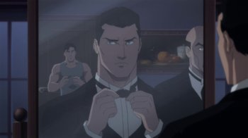 Movie still from “Batman: Hush” (2019), directed by Justin Copeland – A man in a suit and bow tie is looking at the camera; Medium shot, Over the shoulder angle