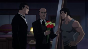 Movie still from “Batman: Hush” (2019), directed by Justin Copeland – A man holding a bouquet of flowers in front of two other men; Wide shot, Over the shoulder angle