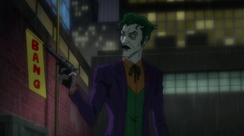 Movie still from “Batman: Hush” (2019), directed by Justin Copeland – The joker is holding a gun in his hand; Medium shot, Over the shoulder angle
