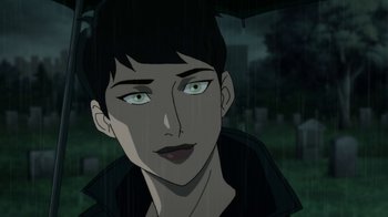 Movie still from “Batman: Hush” (2019), directed by Justin Copeland – A woman with green eyes is standing under an umbrella in the rain; Close Up shot, Over the shoulder angle