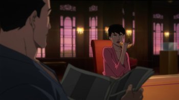 Movie still from “Batman: Hush” (2019), directed by Justin Copeland – A man and a woman sitting in front of each other in a room; Medium shot, Over the shoulder angle