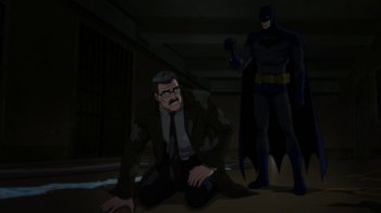 Movie still from “Batman: Hush” (2019), directed by Justin Copeland – A man in a business suit and a batman in a dark room; Wide shot, High angle