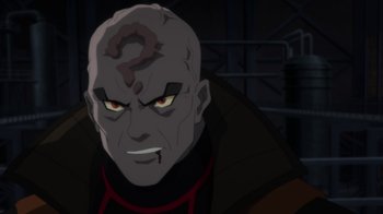 Movie still from “Batman: Hush” (2019), directed by Justin Copeland – A person with a question mark on their face; Close Up shot, Over the shoulder angle