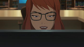 Movie still from “Batman: The Killing Joke” (2016), directed by Sam Liu – A woman wearing glasses looking at a computer screen; Close Up shot, Over the shoulder angle