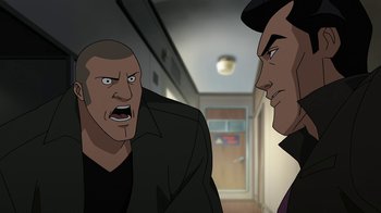 Movie still from “Batman: The Killing Joke” (2016), directed by Sam Liu – Two men are standing in the hallway of a building; Medium shot, Over the shoulder angle