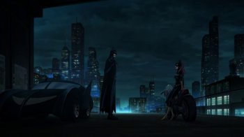 Movie still from “Batman: The Killing Joke” (2016), directed by Sam Liu – A scene of batman and harley quinn in a city at night; Extreme Wide shot, High angle