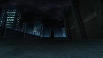 Movie still from “Batman: The Killing Joke” (2016), directed by Sam Liu – A man standing in the middle of a city at night; Extreme Wide shot, Low angle