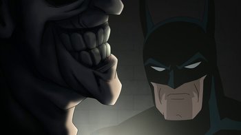 Movie still from “Batman: The Killing Joke” (2016), directed by Sam Liu – Batman's face in a dark room; Close Up shot, Over the shoulder angle