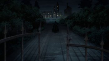 Movie still from “Batman: The Killing Joke” (2016), directed by Sam Liu – A person is sitting in the middle of a road; Extreme Wide shot, High angle