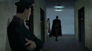 Movie still from “Batman: The Killing Joke” (2016), directed by Sam Liu – A man and a woman in a hallway with batman; Wide shot, Over the shoulder angle