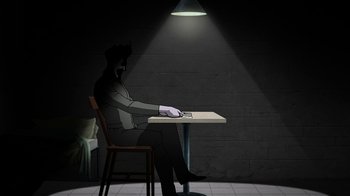Movie still from “Batman: The Killing Joke” (2016), directed by Sam Liu – A man sitting at a table in a dark room; Wide shot, High angle