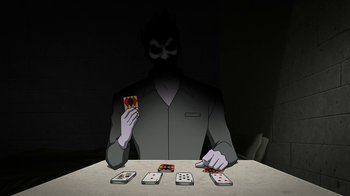Movie still from “Batman: The Killing Joke” (2016), directed by Sam Liu – A man is holding a card while sitting at a table; Medium shot, Over the shoulder angle