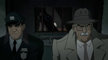 Movie still from “Batman: The Killing Joke” (2016), directed by Sam Liu – Two men are standing in front of a jail cell; Medium shot, Over the shoulder angle