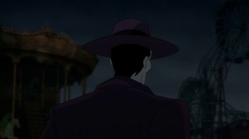 Movie still from “Batman: The Killing Joke” (2016), directed by Sam Liu – A man in a purple coat and a purple hat is talking on a cell phone; Medium shot, Over the shoulder angle