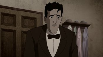 Movie still from “Batman: The Killing Joke” (2016), directed by Sam Liu – A man wearing a suit and bow tie in a room; Close Up shot, Over the shoulder angle