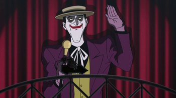 Movie still from “Batman: The Killing Joke” (2016), directed by Sam Liu – A cartoon picture of the joker on a stage; Medium shot, Over the shoulder angle