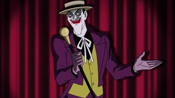 Movie still from “Batman: The Killing Joke” (2016), directed by Sam Liu – A cartoon of the joker holding a microphone; Medium shot, Over the shoulder angle