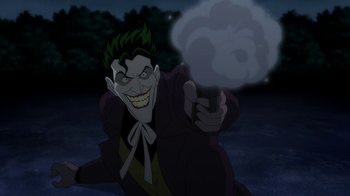 Movie still from “Batman: The Killing Joke” (2016), directed by Sam Liu – The joker is holding something in his hand; Medium shot, Over the shoulder angle