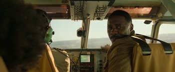 Movie still from “Beast” (2022), directed by Baltasar Kormákur – A man in the cockpit of an airplane; Medium shot, Low angle